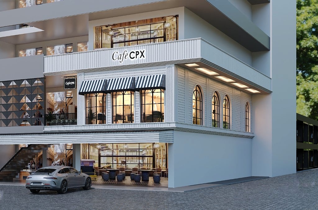 A corner view of the Cafe CPX building, the ribbed white facade and striped awnings above a warmly lit ground-floor cafe seen through full-height glazing