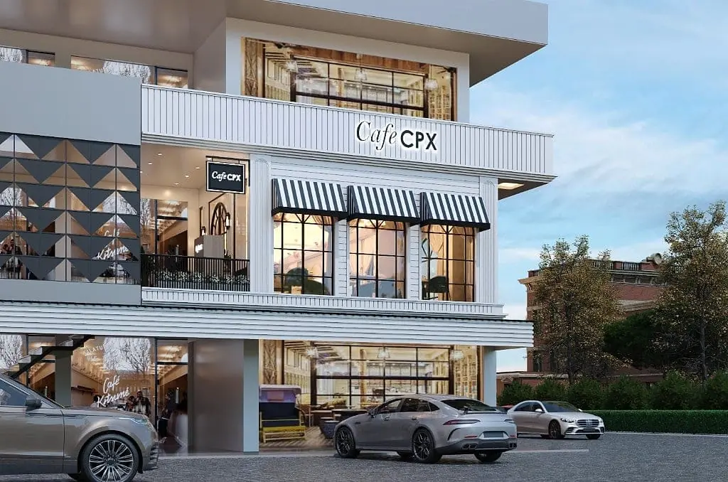 The Cafe CPX facade, a white ribbed and panelled frontage with black-and-white striped awnings, arched windows, double-height glazing and a black-and-brass Cafe CPX sign