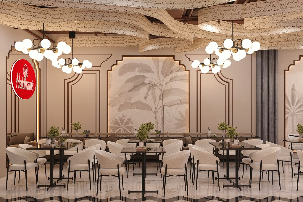 Café dining hall beneath the ribbon ceiling, with botanical murals in Mughal-arched panels