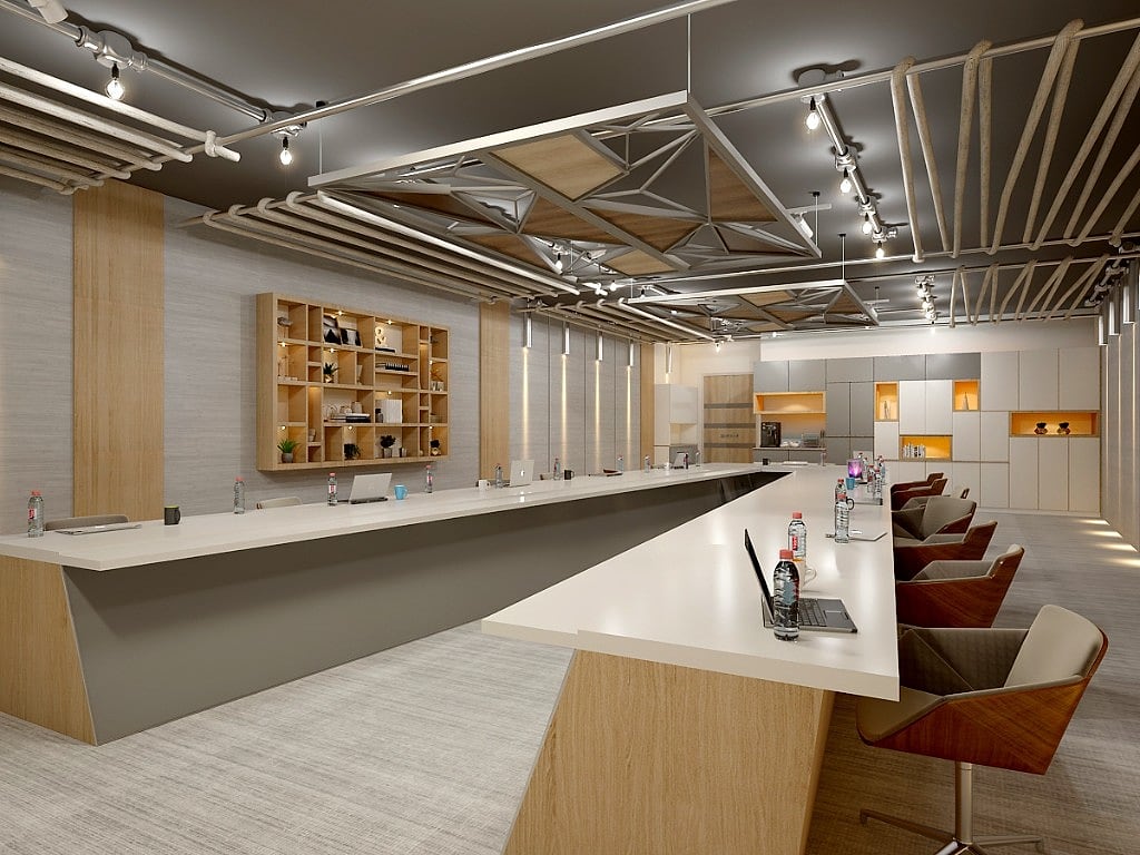 The hotel's business and events floor, long working tables beneath a sculptural triangulated timber-and-metal ceiling, with built-in shelving and track lighting
