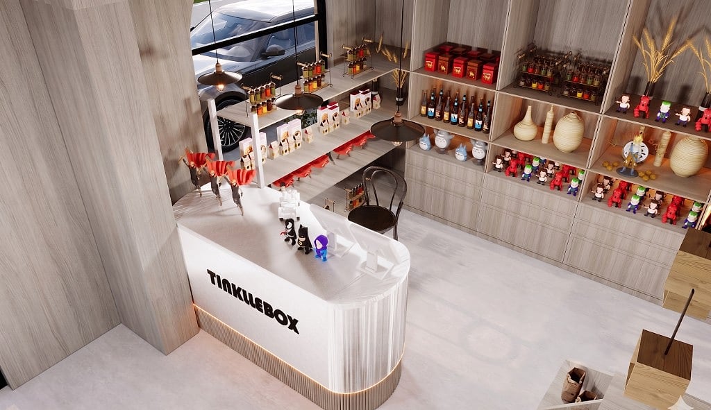 An overhead view of the TinklleBox counter, a white curved counter with the logo and collectible figurines beside warm oak shelving stocked with gifts