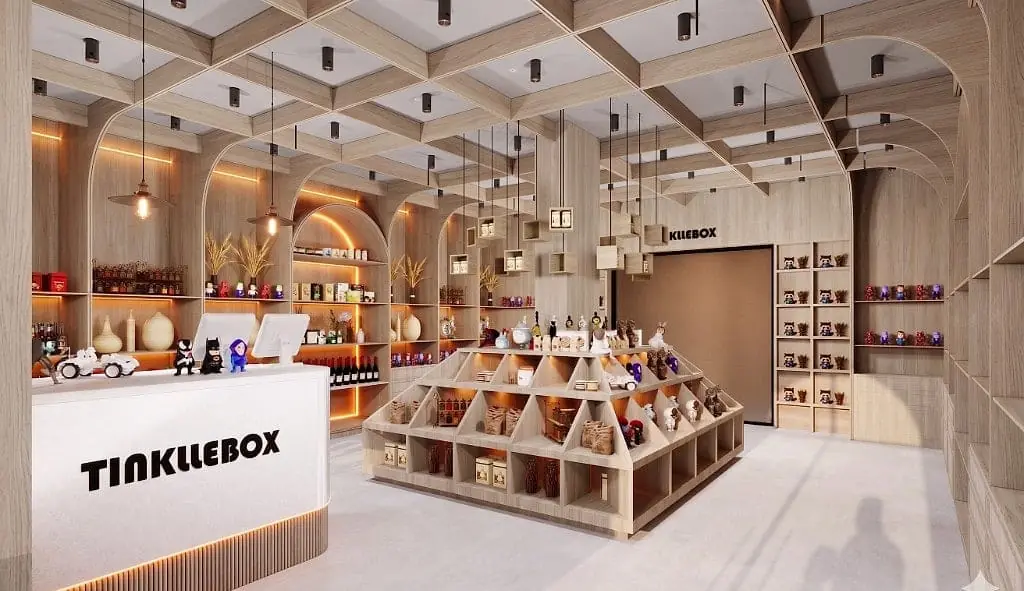 The TinklleBox interior, a white fluted counter with the logo beside a central stepped oak pyramid display, wrapped by floor-to-ceiling arched oak shelving under a coffered timber ceiling