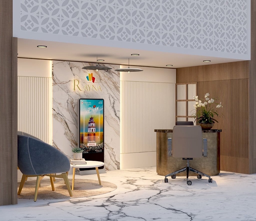 An angled view of the travel desk showing the curved antique-brass counter with a marble top, timber slat wall, orchid styling and the lattice ceiling valance above