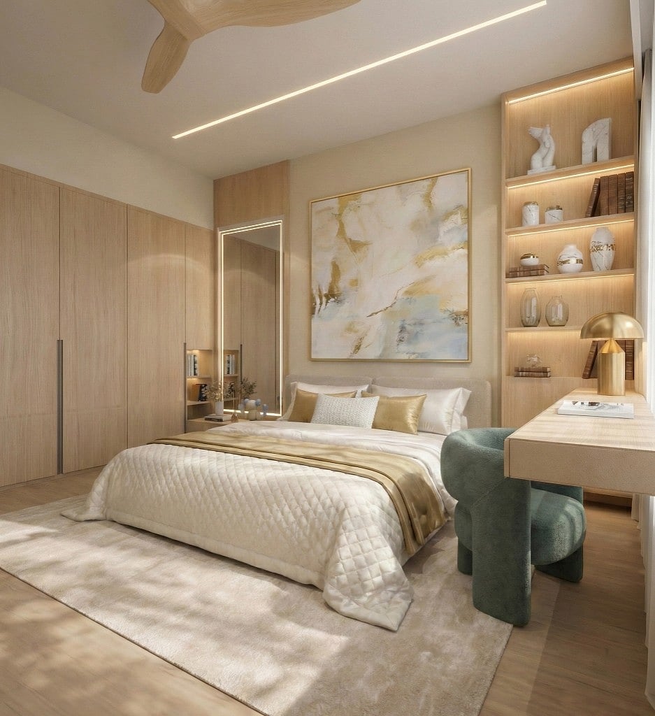 The oak-and-champagne master suite, a backlit display niche with a brass dome lamp beside a gold and pale-blue abstract canvas, a quilted cream bed, full-height oak wardrobes and a green boucle accent chair