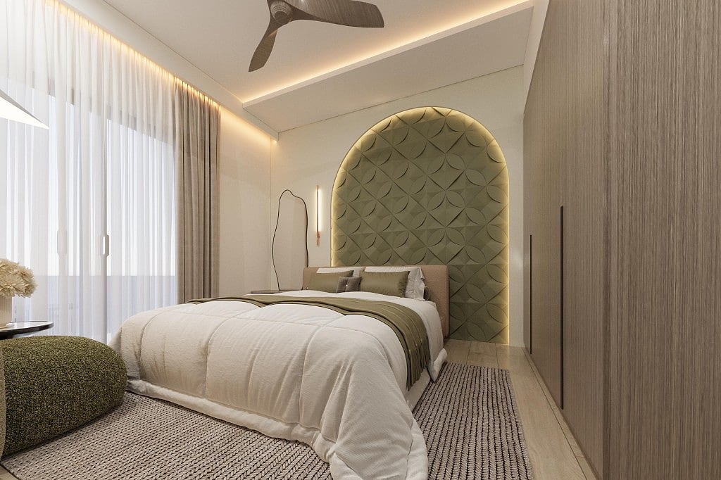 Guest bedroom in the Al Furjan villa with a tall sage-green arched headboard panel in a backlit petal pattern, a white duvet with an olive throw, a wavy mirror and full-height oak wardrobes