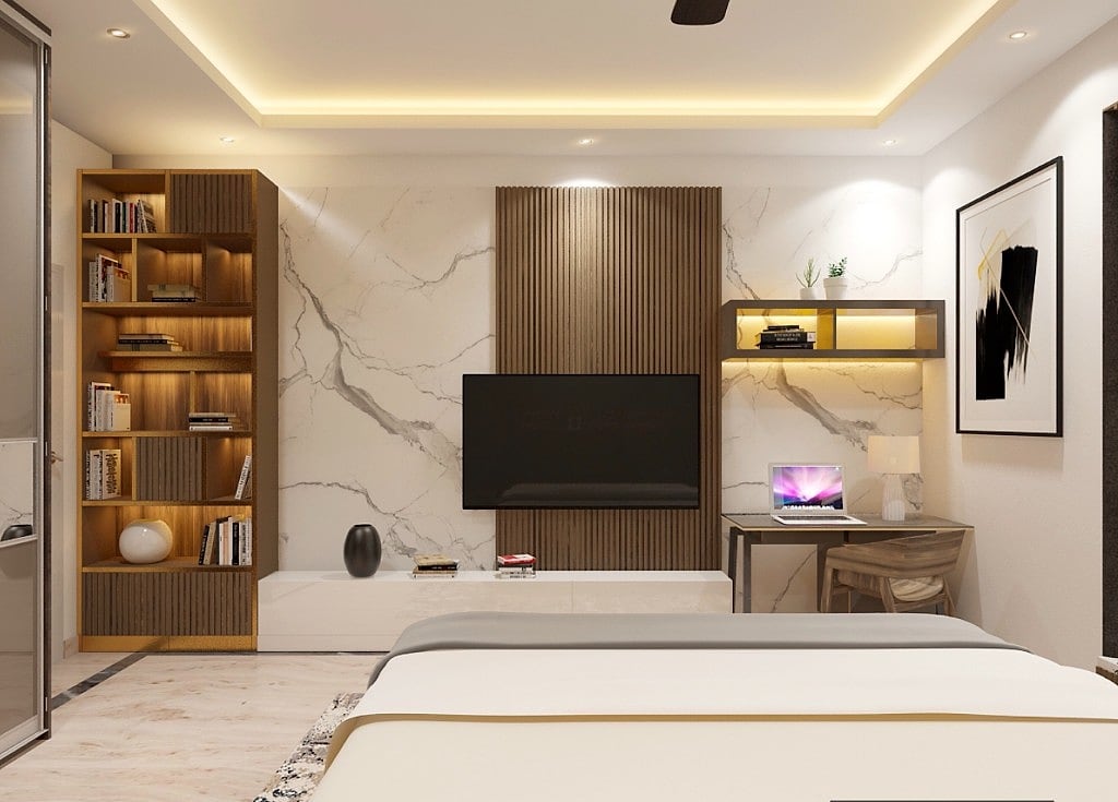 A bedroom that doubles as a study, a book-matched marble and fluted-wood television wall, a tall backlit bookcase, a slim desk with a laptop and framed abstract art