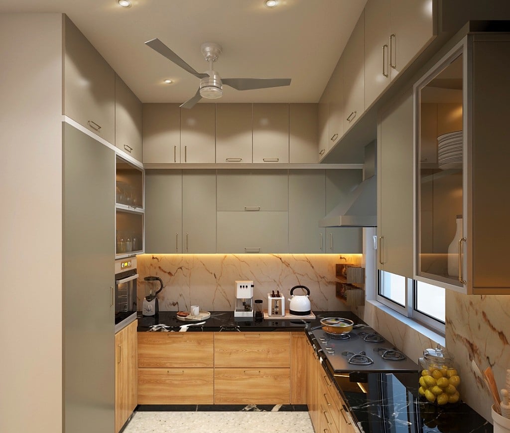 A second kitchen view, a U-shaped layout in grey-green and wood with a marble backsplash, black counters, a chimney hood and a ceiling fan